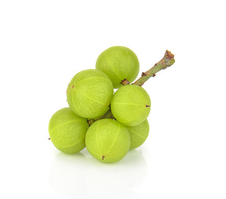 Bunch of green Amla berries on white background used in Vedic Tiger's Gut cleansing Happy Belly dietary supplement to cure leaky gut and digestion issues